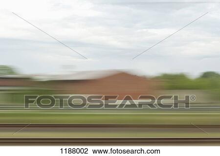 A landscape with buildings in blurred motion, viewed from moving train View Large Photo Image Stock Image - A landscape with buildings in blurred motion, viewed from moving train. Fotosearch
