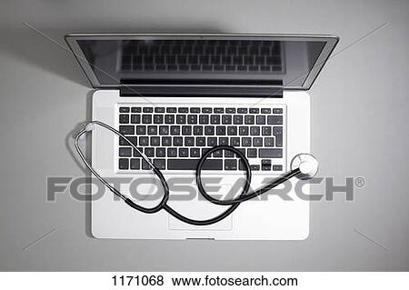 Stock Photo - A laptop with a stethoscope lying on top of it. Fotosearch