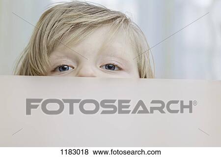 A little girl peeking over a table View Large Photo Image Stock Photo - A little girl peeking over a table. Fotosearch
