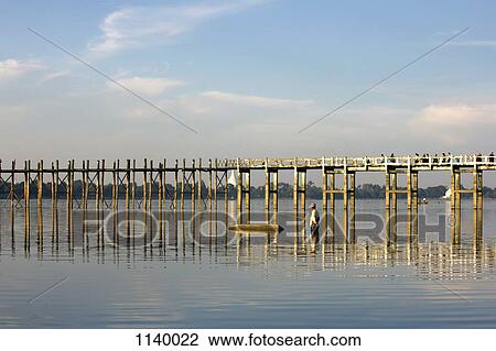 A man fishing next to U Bein Bridge, Amarapura, Burma View Large Photo Image Stock Image - A man fishing next to U Bein Bridge, Amarapura, Burma. Fotosearch