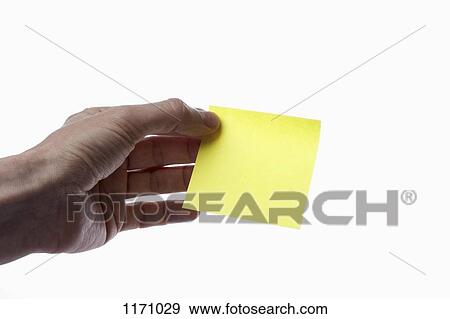A man holding a blank yellow adhesive note, close-up of hand View Large Photo Image Stock Photo - A man holding a blank yellow adhesive note, close-up of hand. Fotosearch