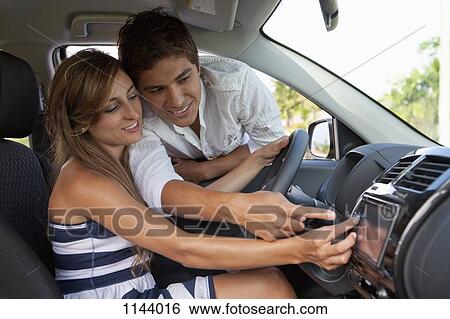 A man leaning in car window helping his girlfriend with the GPS View Large Photo Image Stock Photograph - A man leaning in car window helping his girlfriend with the GPS. Fotosearch