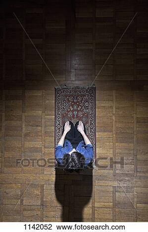 A man praying on a mat View Large Photo Image Stock Image - A man praying on a mat. Fotosearch