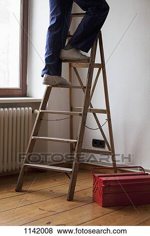 A man standing on a ladder, low section View Large Photo Image Stock Photo - A man standing on a ladder, low section. Fotosearch