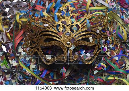 A masquerade mask nestled among confetti and streamers View Large Photo Image Stock Image - A masquerade mask nestled among confetti and streamers. Fotosearch