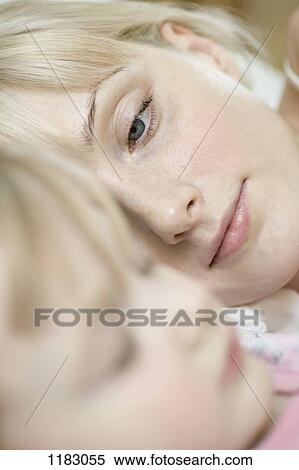 A mother watching her sleeping young daughter View Large Photo Image Stock Photography - A mother watching her sleeping young daughter. Fotosearch