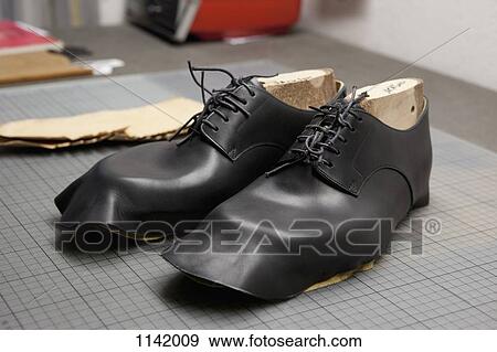 Stock Photo - A pair of shoes being made. Fotosearch