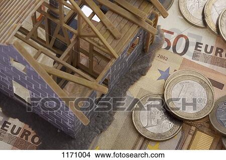 A partially constructed miniature model of a house standing on top of European Union currency View Large Photo Image Picture - A partially constructed miniature model of a house standing on top of European Union currency. Fotosearch