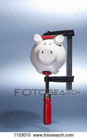 A piggy bank being held in a vise grip suspended in mid-air View Large Photo Image Stock Image - A piggy bank being held in a vise grip suspended in mid-air. Fotosearch
