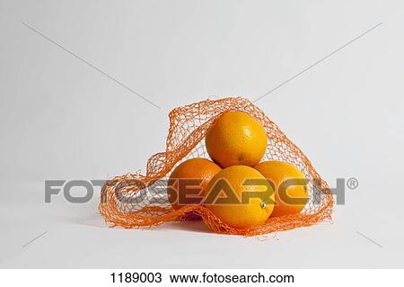 A pile of oranges in an open net bag View Large Photo Image Stock Image - A pile of oranges in an open net bag. Fotosearch