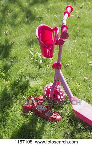 A pink push scooter and pink shoes of a child on grass View Large Photo Image Stock Photo - A pink push scooter and pink shoes of a child on grass. Fotosearch