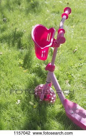 A pink push scooter on grass View Large Photo Image Stock Image - A pink push scooter on grass. Fotosearch