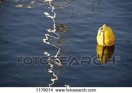 A play of sunlight on water beside buoy View Large Photo Image Picture - A play of sunlight on water beside buoy. Fotosearch