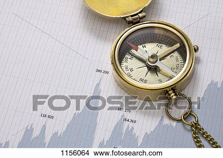 A pocket compass on top of a line graph of financial figures View Large Photo Image Picture - A pocket compass on top of a line graph of financial figures. Fotosearch