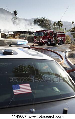 A police car and a fire truck at the scene of a burning house in a suburb View Large Photo Image Stock Photo - A police car and a fire truck at the scene of a burning house in a suburb. Fotosearch