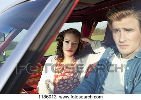 A pretty rockabilly girl looking at her boyfriend in irritation while sitting in vintage car View Large Photo Image Stock Image - A pretty rockabilly girl looking at her boyfriend in irritation while sitting in vintage car. Fotosearch