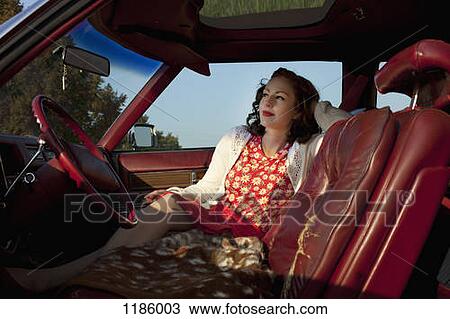 A pretty rockabilly woman sitting in the front seat of a vintage car View Large Photo Image Stock Image - A pretty rockabilly woman sitting in the front seat of a vintage car. Fotosearch