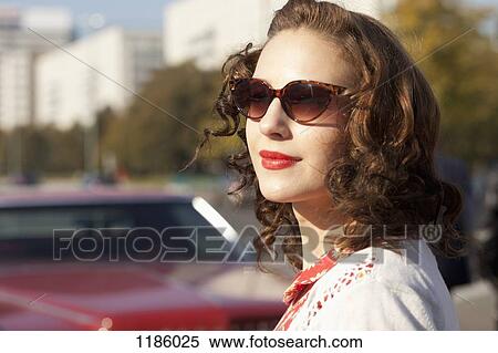 A pretty rockabilly woman standing near a vintage care, focus on woman View Large Photo Image Stock Photography - A pretty rockabilly woman standing near a vintage care, focus on woman. Fotosearch