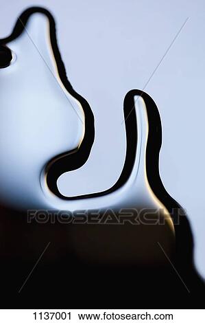 Stock Image - A puddle of black paint, close-up. Fotosearch