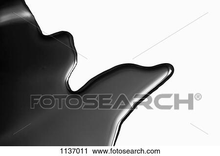 Stock Image - A puddle of black paint, close-up. Fotosearch