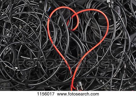 Stock Photo - A red cord in a heart shape amongst tangled black cables and cords. Fotosearch
