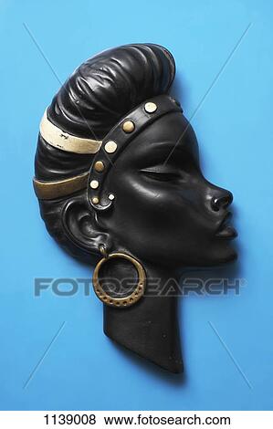 A retro wall hanging of a woman with a headband and earrings View Large Photo Image Stock Photo - A retro wall hanging of a woman with a headband and earrings. Fotosearch