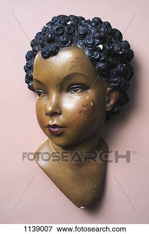 Stock Photo - A retro wall hanging of a woman with short curly hair. Fotosearch