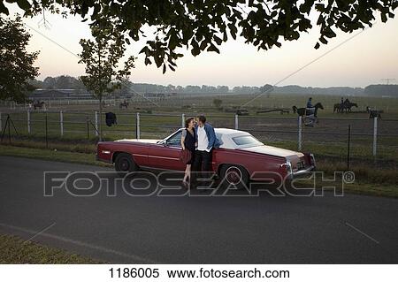A rockabilly couple leaning against a vintage car in the country View Large Photo Image Stock Photography - A rockabilly couple leaning against a vintage car in the country. Fotosearch