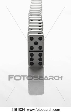 A row of dominoes, close-up, diminishing perspective View Large Photo Image Picture - A row of dominoes, close-up, diminishing perspective. Fotosearch
