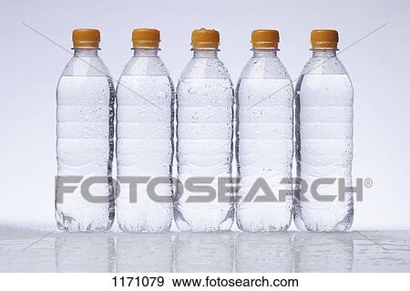 A row of five full plastic water bottles in a row View Large Photo Image Stock Photo - A row of five full plastic water bottles in a row. Fotosearch