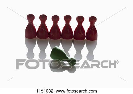 A row of red game pieces with a green piece knocked over in front of them View Large Photo Image Stock Image - A row of red game pieces with a green piece knocked over in front of them. Fotosearch