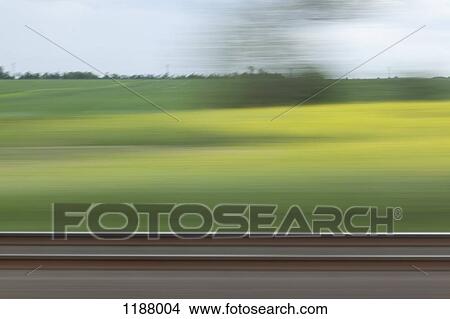 A rural landscape in blurred motion viewed from a moving train View Large Photo Image Picture - A rural landscape in blurred motion viewed from a moving train. Fotosearch