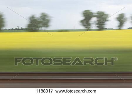 A rural landscape in blurred motion viewed from a moving train View Large Photo Image Stock Photo - A rural landscape in blurred motion viewed from a moving train. Fotosearch