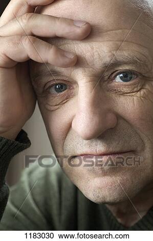A senior man with his hand on his forehead, close-up View Large Photo Image Stock Image - A senior man with his hand on his forehead, close-up. Fotosearch