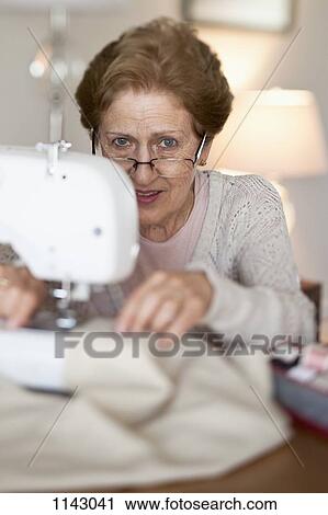 A senior woman sewing View Large Photo Image Stock Image - A senior woman sewing. Fotosearch