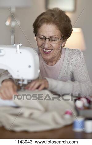 A senior woman sewing View Large Photo Image Stock Image - A senior woman sewing. Fotosearch