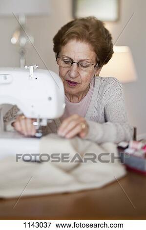 Stock Photo - A senior woman sewing. Fotosearch