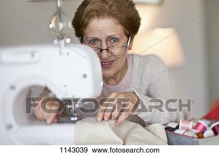 A senior woman sewing View Large Photo Image Stock Photo - A senior woman sewing. Fotosearch