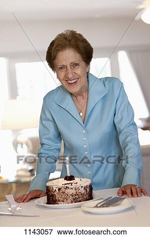 A senior woman with a cake View Large Photo Image Stock Photo - A senior woman with a cake. Fotosearch