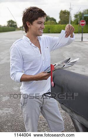 A smiling man getting his mail from a mailbox View Large Photo Image Picture - A smiling man getting his mail from a mailbox. Fotosearch