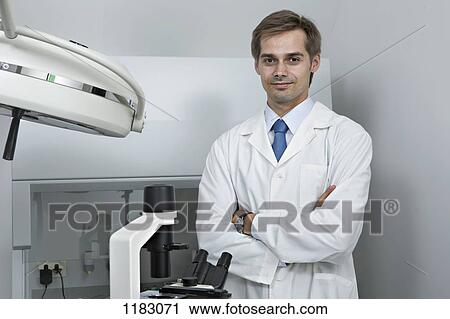 A smiling research technician standing in a research lab View Large Photo Image Stock Image - A smiling research technician standing in a research lab. Fotosearch