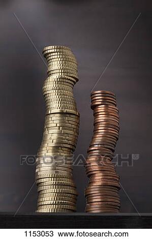 Stock Image - A stack of gold Euro coins next to a stack of copper Euro coins. Fotosearch