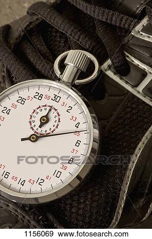 A stopwatch lying on top of a sports shoe, close-up View Large Photo Image Stock Photo - A stopwatch lying on top of a sports shoe, close-up. Fotosearch