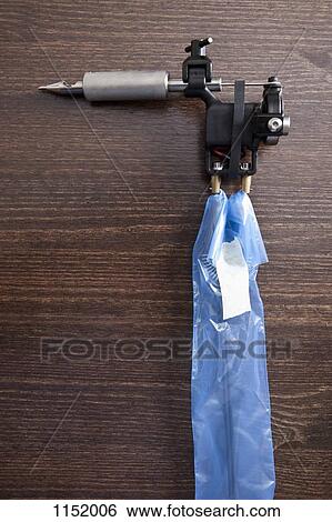 A tattoo gun on a table, close-up View Large Photo Image Stock Photograph - A tattoo gun on a table, close-up. Fotosearch