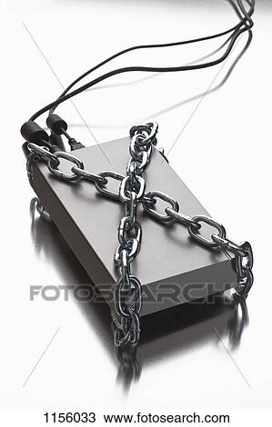A thick metal chain wrapped around an external hard drive View Large Photo Image Stock Image - A thick metal chain wrapped around an external hard drive. Fotosearch