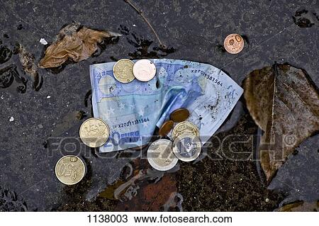 A twenty euro banknote and euro coins in a puddle View Large Photo Image Stock Image - A twenty euro banknote and euro coins in a puddle. Fotosearch