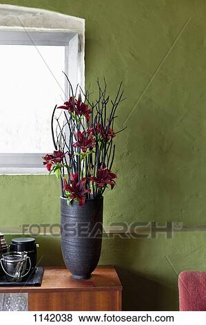 A vase of flowers on a sideboard View Large Photo Image Stock Photo - A vase of flowers on a sideboard. Fotosearch