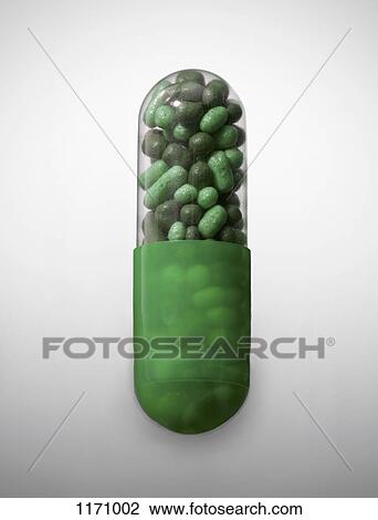 Stock Image - A vibrant green capsule pill, close-up. Fotosearch