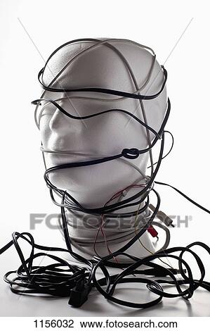 Stock Image - A white mannequin bust entangled in various cords and cables. Fotosearch