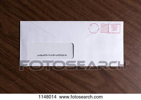 A window envelope with no address, but a barcode and red ink postage stamp View Large Photo Image Picture - A window envelope with no address, but a barcode and red ink postage stamp. Fotosearch